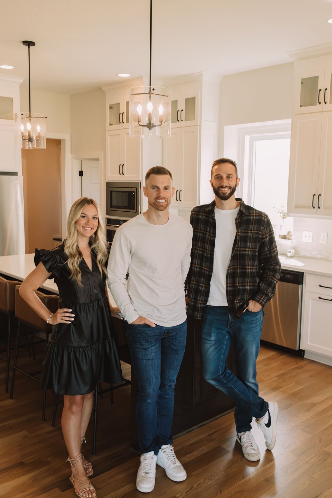 Kimberlin Tilton, Tanner Garver and Cam Walker of the Garver Group standing in a bright kitchen